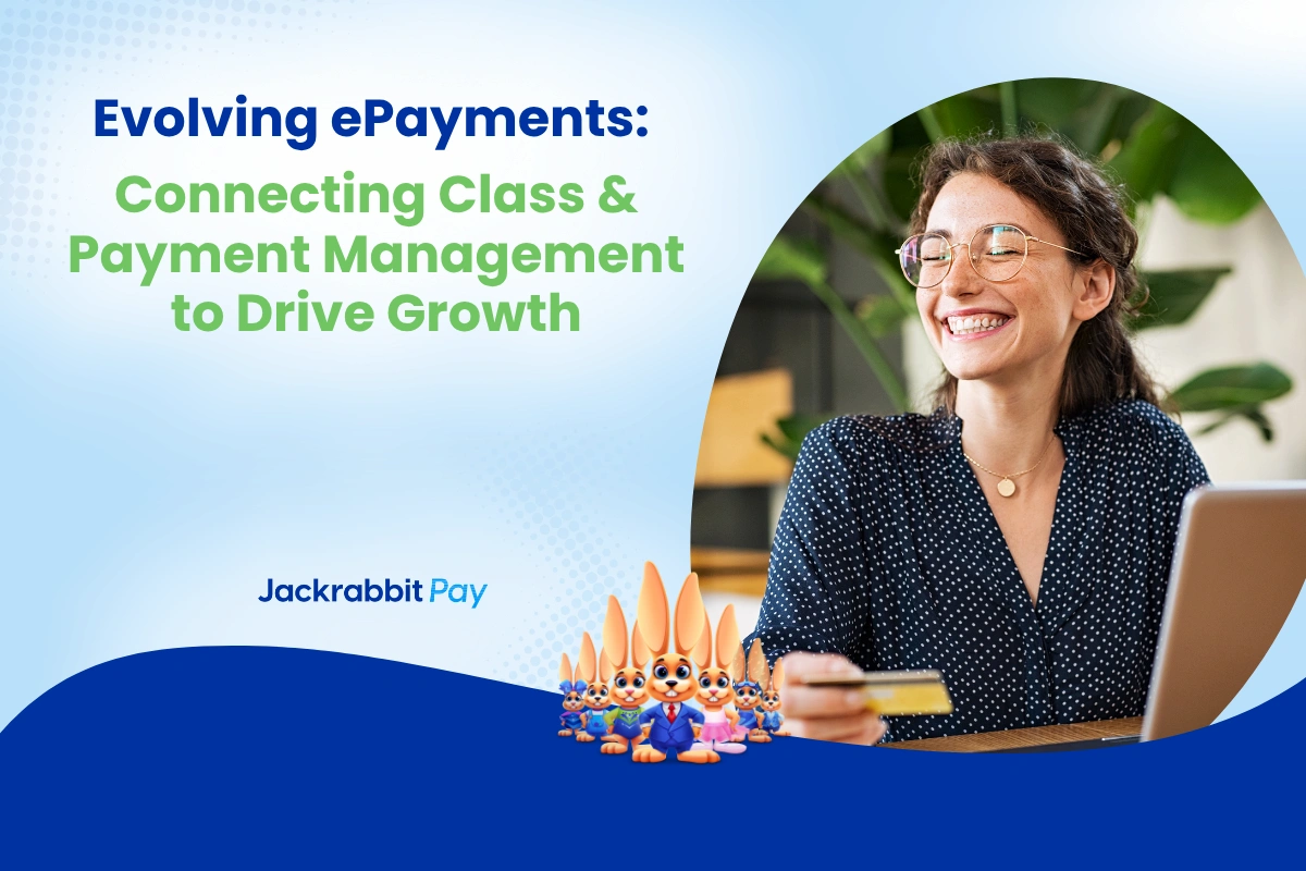 happy woman with credit card in hand in front of computer